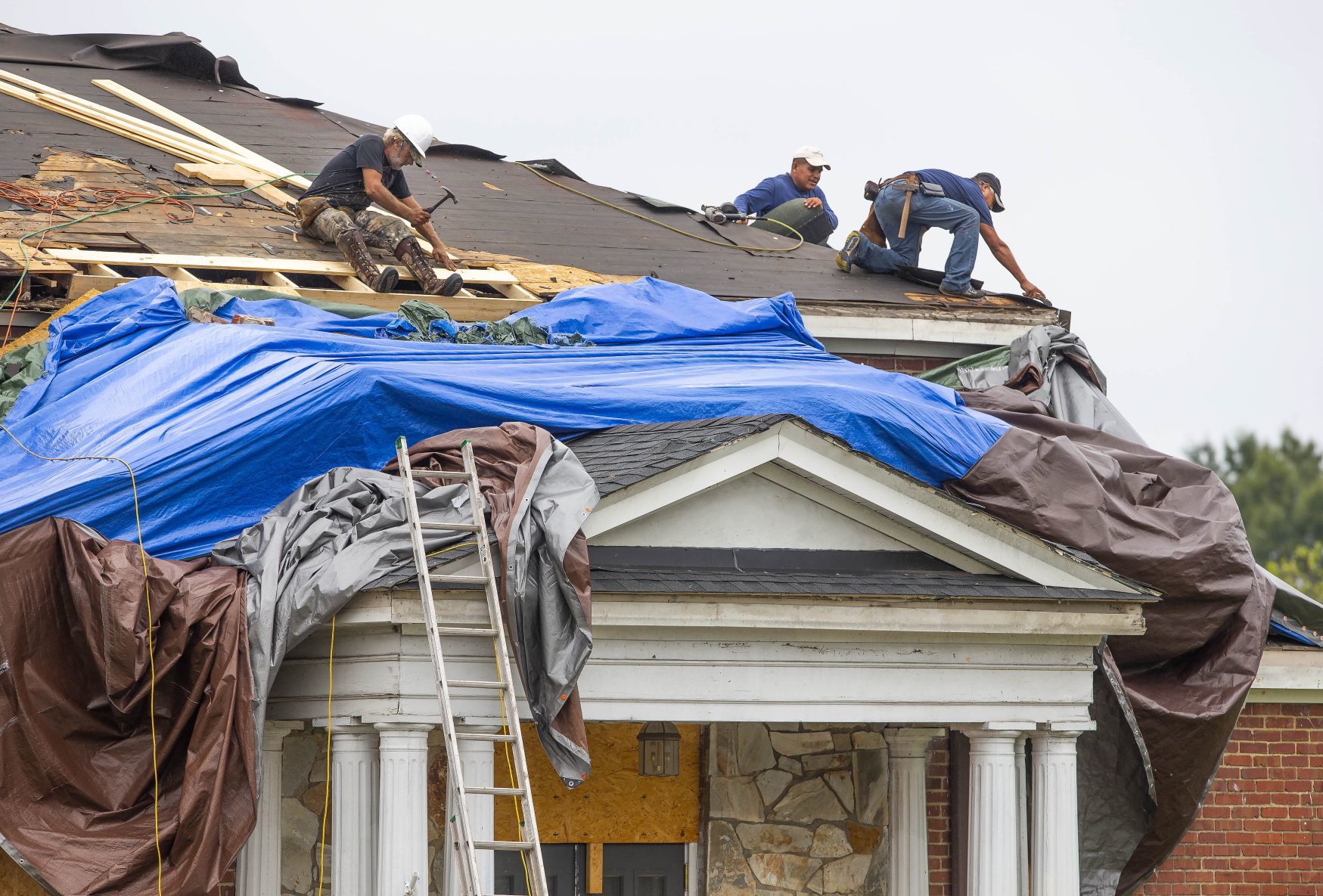 As residents rebuild, face threat of hurricane